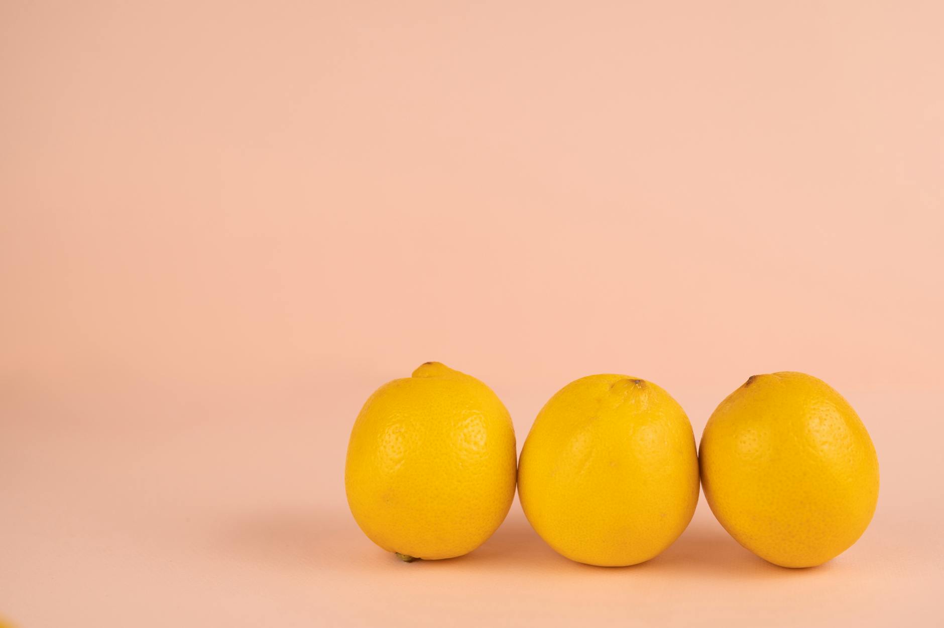 Bright ripe lemons on a pastel background, representing the natural cycles and rhythms of the body